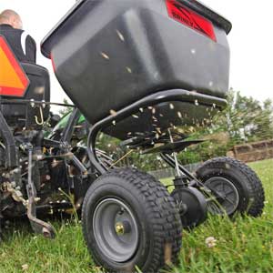 Pull behind spreader for lawn mower